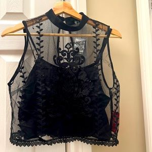 Black see through top with design. It also has a black spaghetti blouse